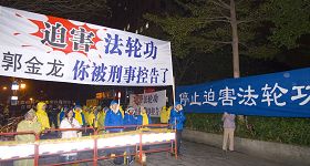 '十八日晚，法轮功学员在台大体育馆入口处守候北京市长郭金龙一行人，抗议郭金龙等人迫害法轮功'