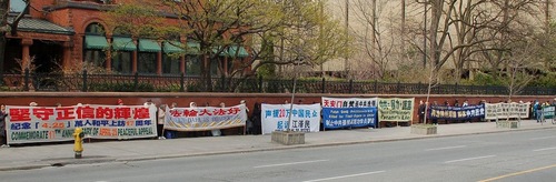 Praktisi Falun Gong membentangkan spanduk di pusat kota Toronto