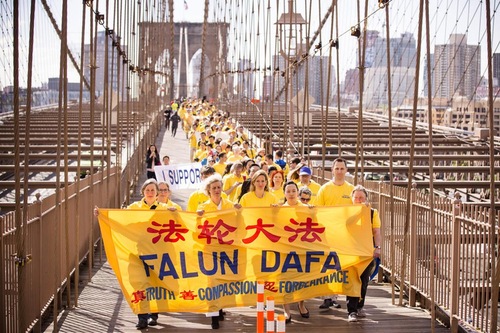 Praktisi Falun Dafa di Kota New York berjalan di Jembatan Brooklyn di Kota New York pada tanggal 15 Mei 2015.