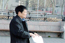 Mr. Guo Chuanjie, the Vice Secretary of the Chinese Communist Party Committee for the Chinese Academy of Sciences, pictured here being served with legal papers in New York City's Battery Park. The judgment, entered against him this week, was for claims of genocide, torture, and crimes against humanity.
